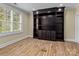 Home office with built-in shelving and hardwood floors at 11052 Preservation Park Dr, Charlotte, NC 28214