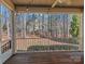 Enclosed porch with wood flooring and a ceiling fan, perfect for enjoying the outdoors at 11052 Preservation Park Dr, Charlotte, NC 28214