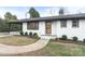 Charming ranch home with a wood front door and manicured landscaping at 111 Horsley Ave, Belmont, NC 28012