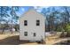 Rear view of a white two-story home with a small back yard at 1310 Essex St, Gastonia, NC 28052