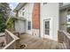 Backyard featuring a wooden deck, white exterior, brick chimney, and access to the house at 132 N Confederate Ave, Rock Hill, SC 29730