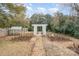 Backyard featuring a white arbor, greenhouse, and garden beds, perfect for outdoor relaxation at 132 N Confederate Ave, Rock Hill, SC 29730