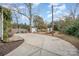Spacious backyard featuring a concrete patio, shed, and mature trees providing shade and privacy at 132 N Confederate Ave, Rock Hill, SC 29730