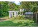 Lush backyard featuring a garden with pergola and greenhouse, perfect for gardening enthusiasts at 132 N Confederate Ave, Rock Hill, SC 29730