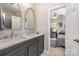 Bathroom featuring double sink vanity, marble countertop, modern faucets, and a view into the adjacent bedroom at 132 N Confederate Ave, Rock Hill, SC 29730