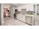 Stylish kitchen features stainless steel appliances, white cabinetry, and tile flooring at 132 N Confederate Ave, Rock Hill, SC 29730