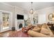 Cozy living room features a fireplace, chandelier, and access to the kitchen at 132 N Confederate Ave, Rock Hill, SC 29730