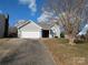 Gray house with white garage door and landscaping at 14333 Blue Granite Rd # 25, Pineville, NC 28134