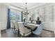 Elegant dining room with large windows, statement wall, and chandelier at 146 Nicholson Ln, Mooresville, NC 28115