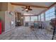 Relaxing sunroom featuring wicker furniture, a ceiling fan, and large windows at 15816 Feeny Ct, Charlotte, NC 28278