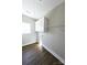 Well-lit laundry room with vinyl floors, white cabinets, and wire shelving at 2222 Badin Rd, Albemarle, NC 28001