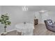 Charming dining area with white table, chandelier, and hardwood floors at 224 Butler Pl, Fort Mill, SC 29715