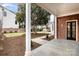 Covered patio leading to a professionally landscaped backyard with mature trees at 2400 Mecklenburg Ave, Charlotte, NC 28205