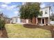 Expansive backyard featuring a lush lawn and stone patio ideal for outdoor entertaining at 2400 Mecklenburg Ave, Charlotte, NC 28205