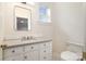 Elegant half-bath featuring a custom vanity with stone countertop and classic fixtures at 2400 Mecklenburg Ave, Charlotte, NC 28205
