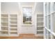 Bright closet space featuring custom built-in shelving and a window for natural light at 2400 Mecklenburg Ave, Charlotte, NC 28205