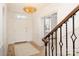 Bright foyer with hardwood floors, white walls, decorative chandelier, and staircase with iron railing at 2400 Mecklenburg Ave, Charlotte, NC 28205