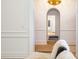 Hallway with hardwood floors, white walls, and arched doorways, leading to other rooms at 2400 Mecklenburg Ave, Charlotte, NC 28205