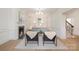 Bright living room featuring a fireplace, hardwood floors, large windows, and elegant furnishings at 2400 Mecklenburg Ave, Charlotte, NC 28205