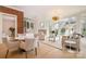 Bright living room with hardwood floors, fireplace, large windows, and elegant chandelier at 2400 Mecklenburg Ave, Charlotte, NC 28205