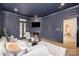 Cozy living room with navy colored walls, fireplace, TV and access to the outside at 2400 Mecklenburg Ave, Charlotte, NC 28205