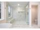 Bathroom with a frameless glass shower, marble tile and a built in bench at 2400 Mecklenburg Ave, Charlotte, NC 28205