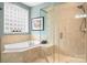 Bathroom with soaking tub, walk-in shower, and a window at 302 Mccrary Rd, Mooresville, NC 28117