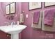 Small bathroom with pedestal sink and a modern mirror at 302 Mccrary Rd, Mooresville, NC 28117