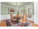 Formal dining room with wood floors, chandelier, and large windows at 302 Mccrary Rd, Mooresville, NC 28117