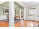 Bright entryway with hardwood floors, white columns, and view into dining area at 302 Mccrary Rd, Mooresville, NC 28117