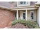 Inviting front porch with classic columns, seating, and a brick walkway leading to the entrance at 302 Mccrary Rd, Mooresville, NC 28117
