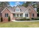 Charming brick and siding home with manicured lawn and beautiful landscaping at 302 Mccrary Rd, Mooresville, NC 28117