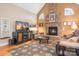 Gathering room with stone fireplace, hardwood floors, and large TV at 302 Mccrary Rd, Mooresville, NC 28117