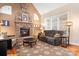 Gathering room with stone fireplace, hardwood floors, and comfortable seating at 302 Mccrary Rd, Mooresville, NC 28117