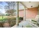 Brick porch with rocking chairs, overlooking a grassy backyard at 302 Mccrary Rd, Mooresville, NC 28117