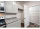 Kitchen with gray cabinets, granite counters, and pantry at 307 Brinkley Dr, Kings Mountain, NC 28086