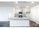 Modern kitchen with gray cabinets, granite counters, and island at 307 Brinkley Dr, Kings Mountain, NC 28086