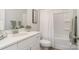 Clean bathroom with white vanity, bathtub, and shower at 336 D Lincoln St, Concord, NC 28025