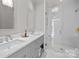 Double vanity bathroom with marble countertops and a shower at 413 Eastover Rd, Charlotte, NC 28207
