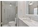 Chevron-tiled bathroom with a shower and marble vanity at 413 Eastover Rd, Charlotte, NC 28207