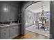 Butlers pantry with gray cabinetry, marble countertops, and wine cooler at 413 Eastover Rd, Charlotte, NC 28207