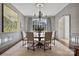 Formal dining room with a large window and elegant chandelier at 413 Eastover Rd, Charlotte, NC 28207
