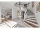 Grand entryway with a curved staircase and tile flooring at 413 Eastover Rd, Charlotte, NC 28207