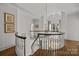Elegant curved staircase landing with hardwood floors and art at 413 Eastover Rd, Charlotte, NC 28207