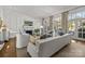 Bright living room featuring hardwood floors, fireplace, and French doors at 413 Eastover Rd, Charlotte, NC 28207