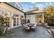 Outdoor patio with stone flooring, dining table, and fountain at 413 Eastover Rd, Charlotte, NC 28207