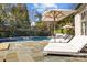 Relaxing pool area with lounge chairs and patio umbrella at 413 Eastover Rd, Charlotte, NC 28207