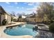Inviting kidney shaped pool with a spa and spacious patio at 413 Eastover Rd, Charlotte, NC 28207
