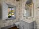 Elegant powder room with gray vanity, patterned wallpaper, and window seat at 413 Eastover Rd, Charlotte, NC 28207