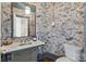 Powder room with marble-topped vanity and nature-themed wallpaper at 413 Eastover Rd, Charlotte, NC 28207